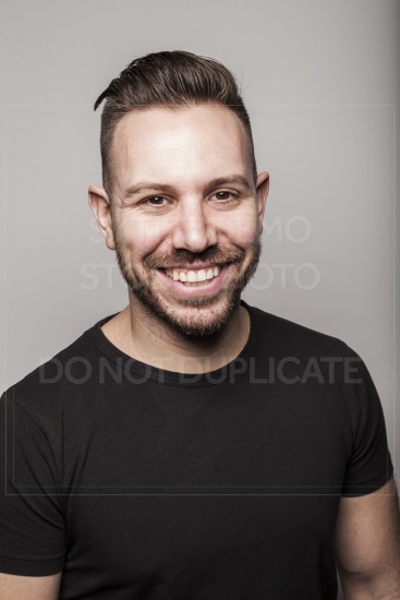 Portrait of young man smiling in studio