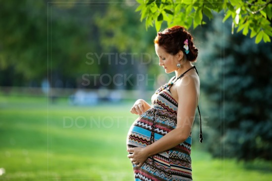 Pregnant  woman takes rest outdoor