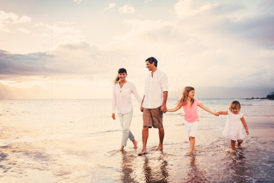 Happy Young Family have Fun Walking on Beach at Sunset